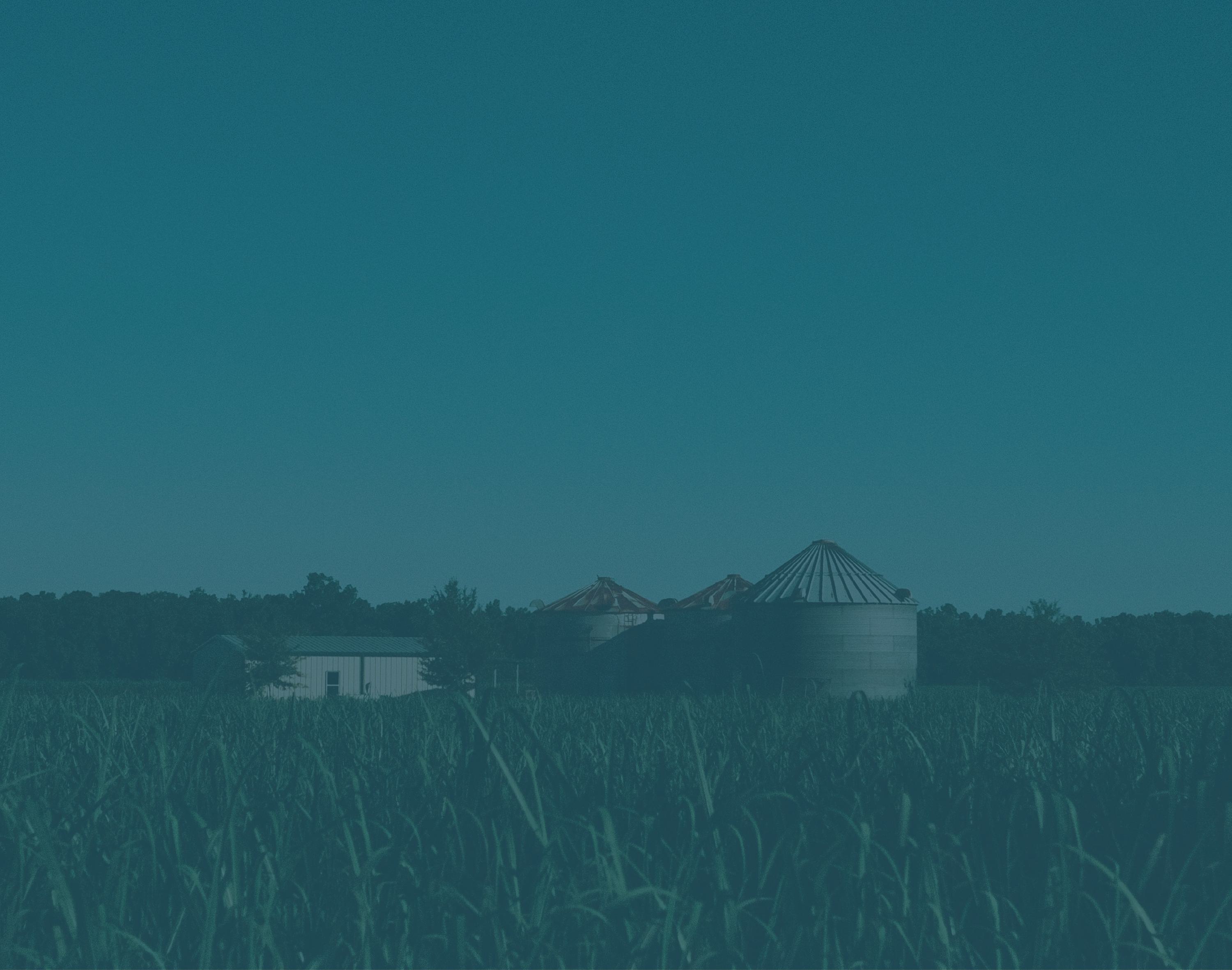 A background image in aerial view of agricultural buildings in the field